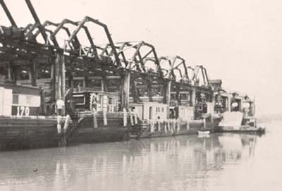Goodwin and Gallagher �stalls�: wooden barges waiting to be loaded with sand, c. 1900