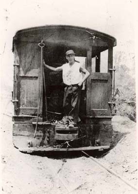 Engineer Bill Bedell runs a �dinkey engine� for Goodwin and Gallagher Sand Company, 1930