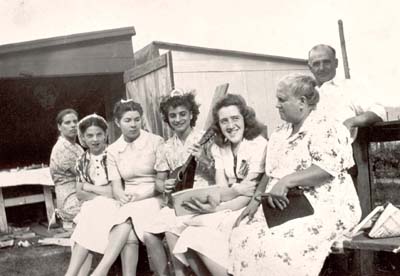 Miners' wives and daughters join in song at a Sunday party. Madeline Giagu on left, early 1940's