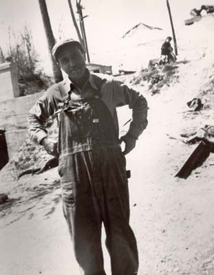 Worker with child in background, 1940