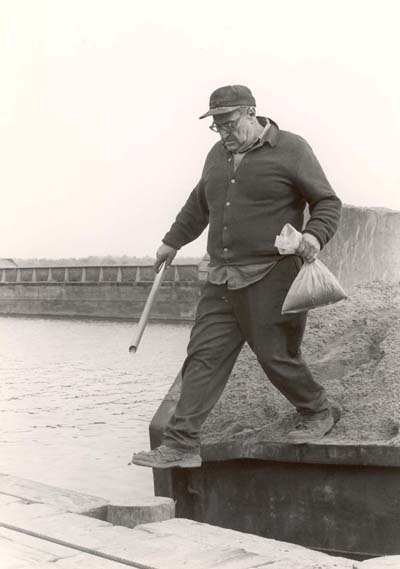 Sandminer Al Marino preparing to test sand sample, 1979
