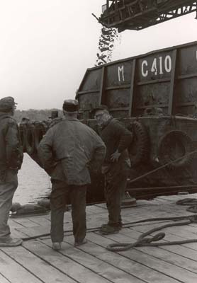 Al Marino, Santo Bassi and worker at McCormack barge waiting for it to be leveled off