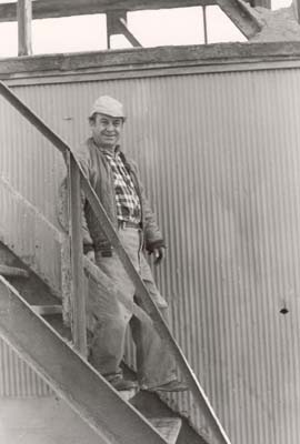 Bastian Madeddu, loader, walks down stairs from control room to dock