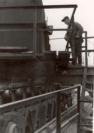 Santo Bassi looking at materials as they travel from plant to loading belt