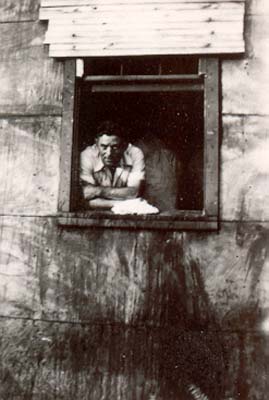 John Frommja at sandbanks house window, c. 1920