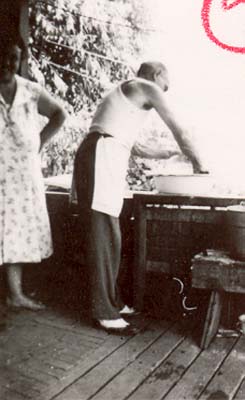 Lodger doing dishes on Palen porch, 1950s
