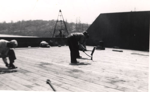 Jerry, welder, and Al Salerno and Red, caulking deck (old �Al Pope� derrick in background), 1956