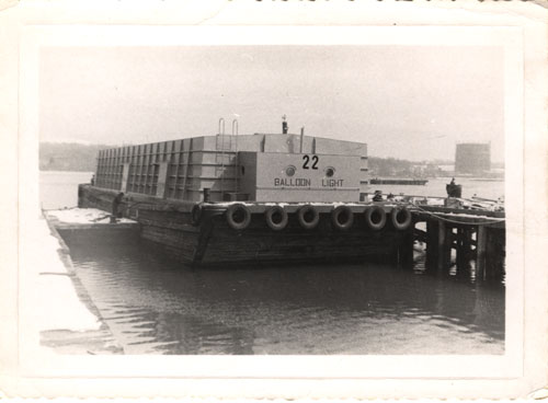 Cement barge ready to go to Kingston, New York, in Colonial Sand Company shipyard (old Lilco gas tank across harbor), late 1960�s