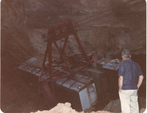 Al Salerno looking at drag line sitting in cave-in hole, 1980