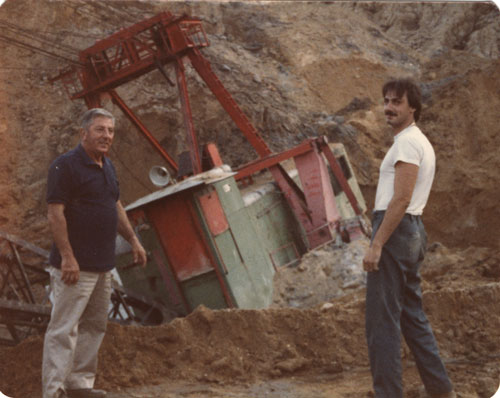 Al Salerno and oiler, Mike Luciano in cave-in hole with drag line machine, 1980