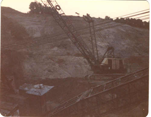 Digging out drag line from cave-in hole, 35 feet deep, 1980
