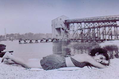 Sunbathing at sandbank beach, West Shore Road, c.1940